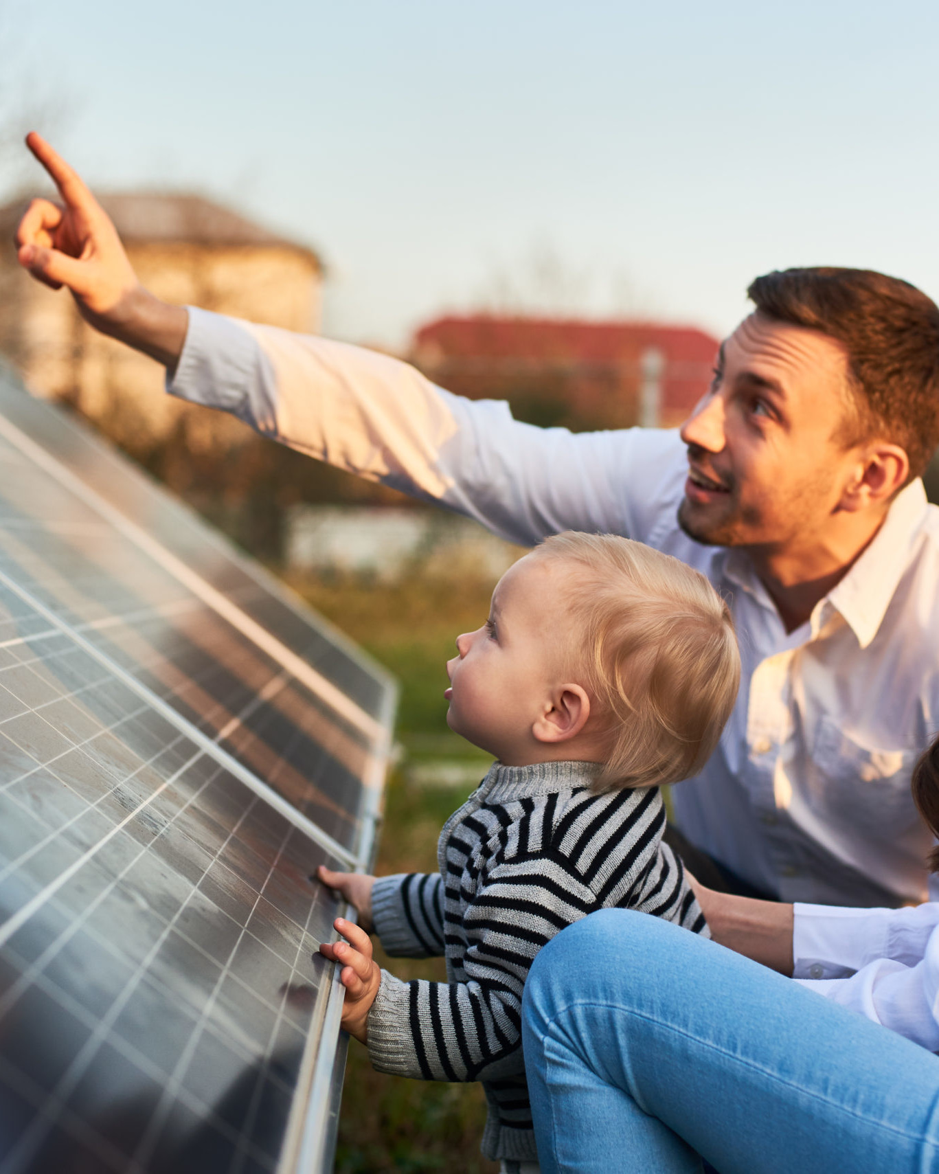 Foreldre og barnet deres ser på et solcellepanel